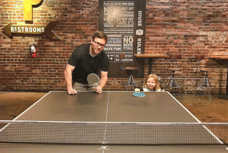 Coltin and Raven playing ping pong at Eat Ace Serve in Denver