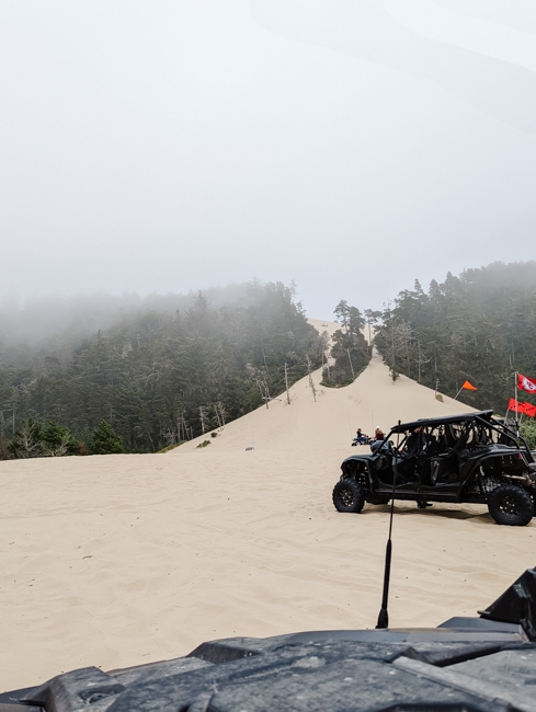 Watching riders climb the sand dunes at Banshee Hill.