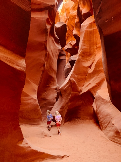 Girls walking through the slot canyon near Page, AZ