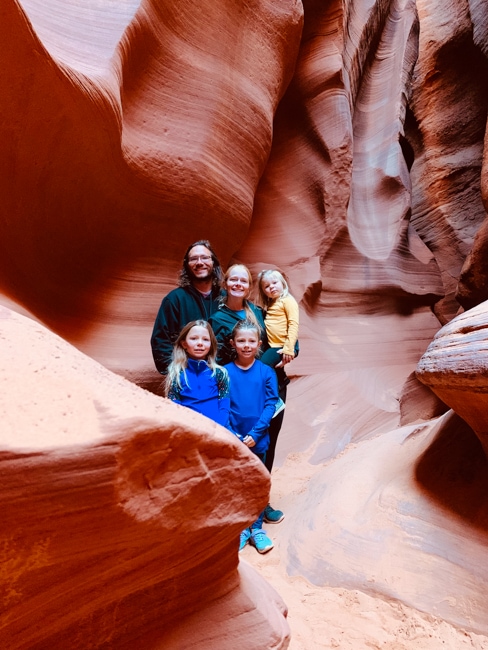 Family exploring a slot canyon