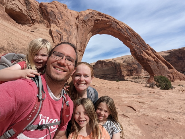 Family in front of Corona Arch in Moab