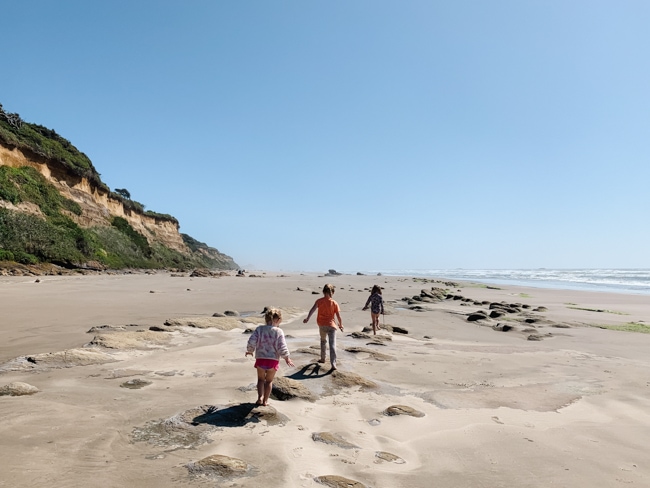 Kids playing on the beach on an Oregon Coast road trip