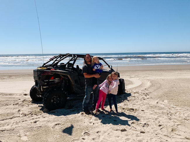 Family with a rzr on the beach