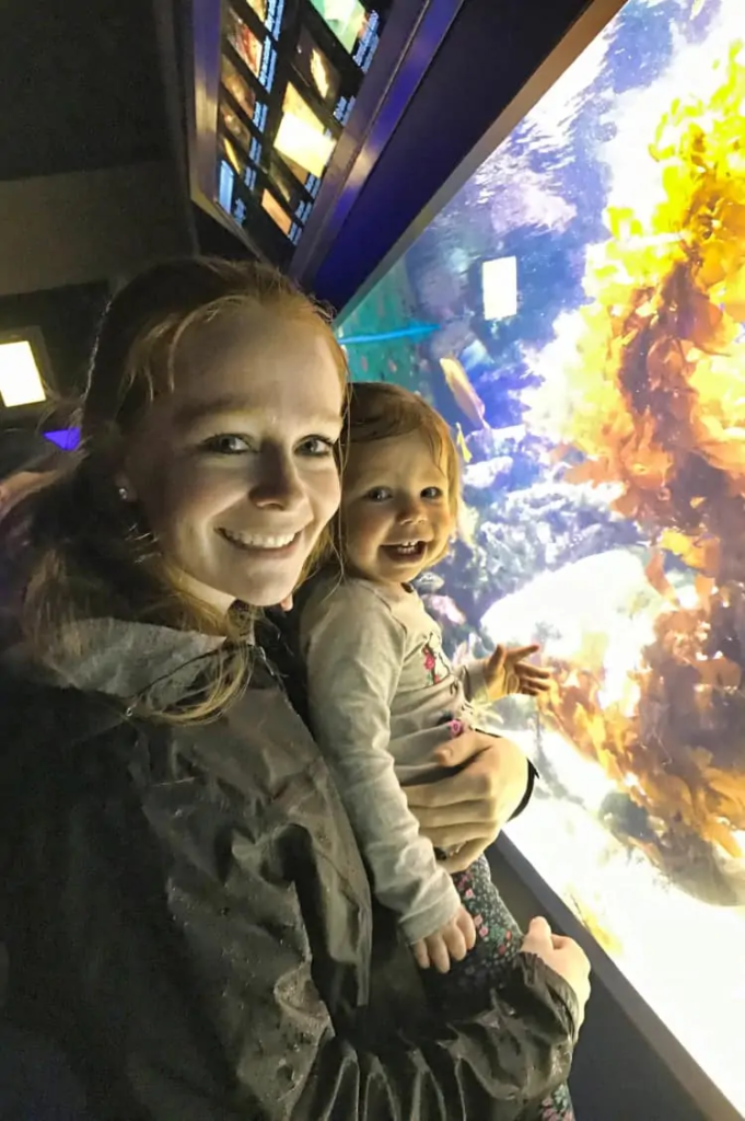 Mom and daughter visiting the Birch Aquarium in their San Diego itinerary