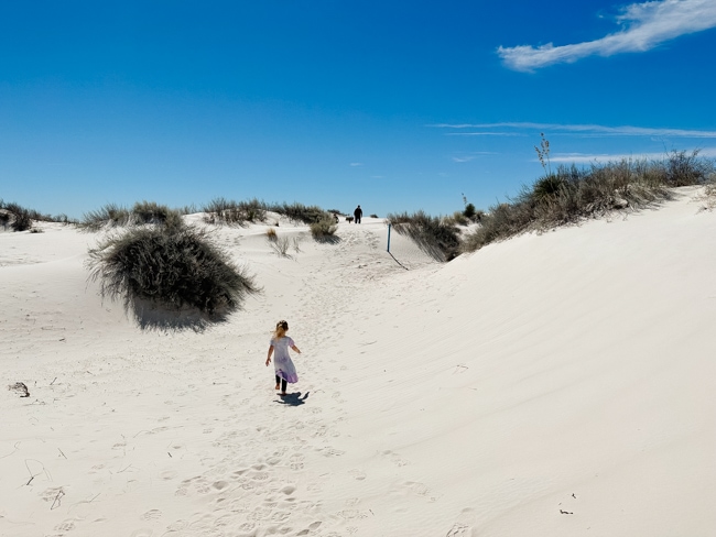 Child walking through the sand dunes