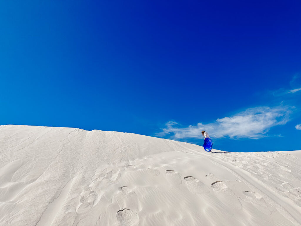 Daughter playing on the sand dunes in White Sands National Park