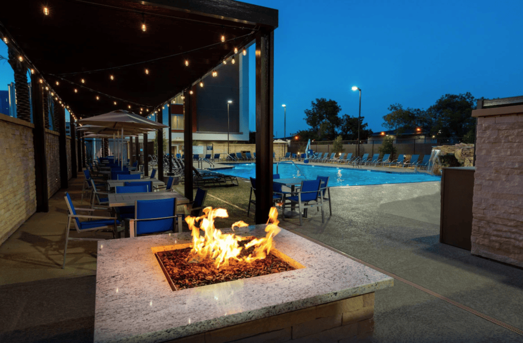 Fire pit, patio area and swimming pool at Holiday Inn Express & Suites Las Vegas - E Tropicana, one of the best hotels near the Las Vegas Airport.