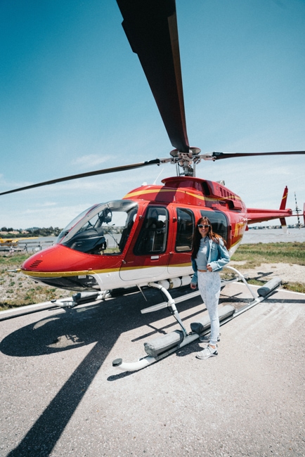 Woman posing near a helicopter used for a Las Vegas helicopter tour