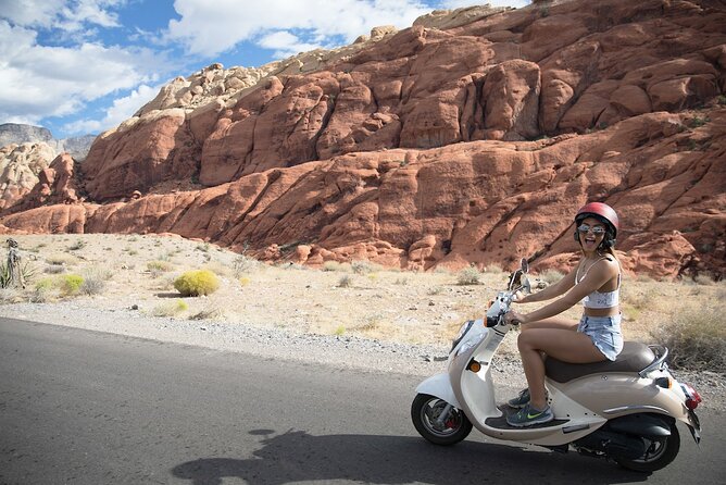 Woman driving a scooter through Red Rock Canyon