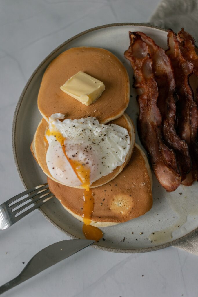A plate full of pancakes, bacon, and eggs from Pig 'n Pancake, one of the best Lincoln City restaurants.