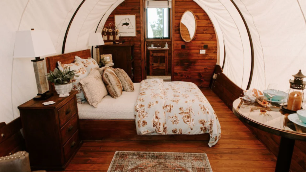Sleeping area inside a covered wagon at The Grand Canyon Glamping Resort.