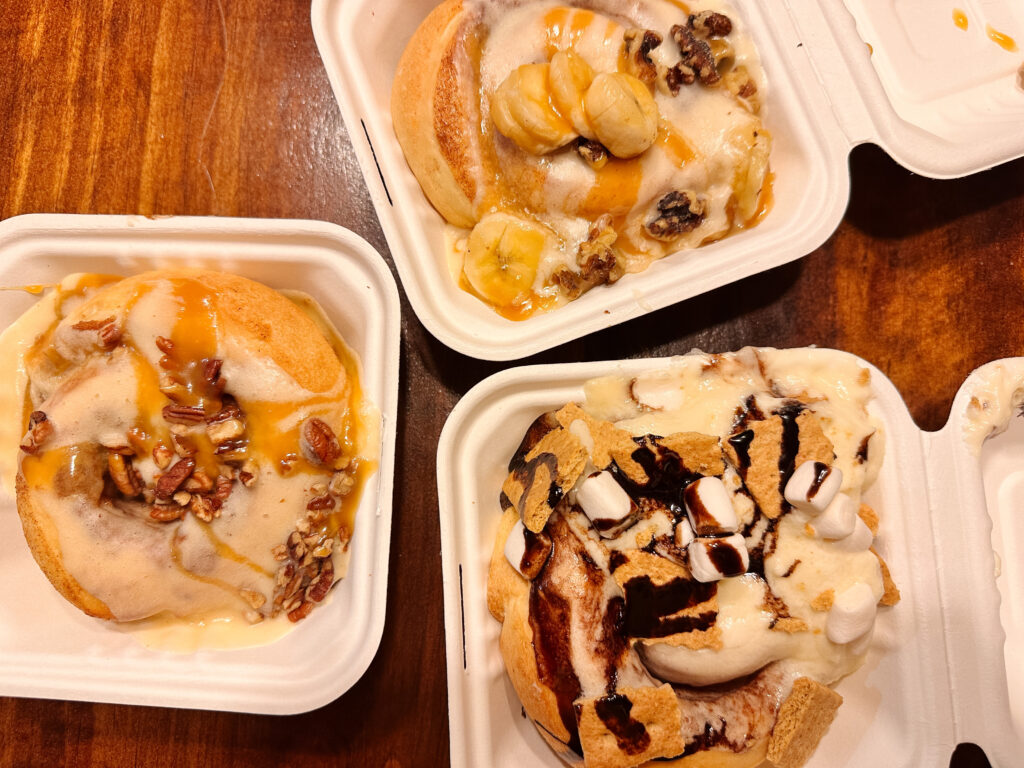 Cinnamon rolls from Cinnaholic in to-go boxes.