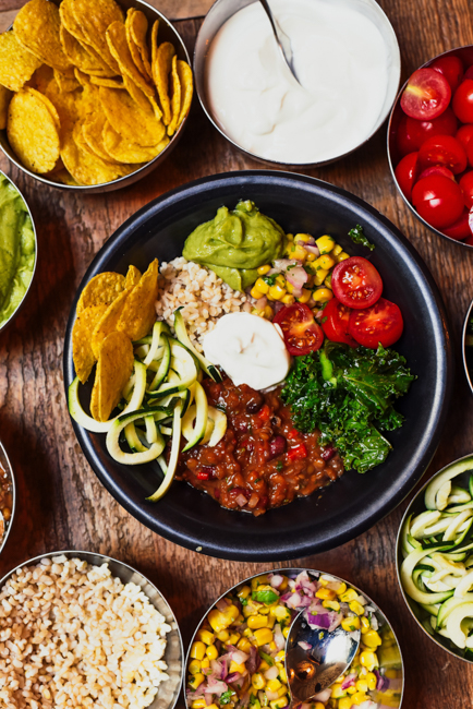 Table top full of bowls of healthy taco ingredients used at High Note Cafe, one of the best Boise restaurants.