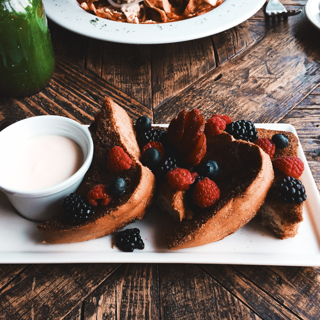 A plate of french toast covered in berries at Stardust.