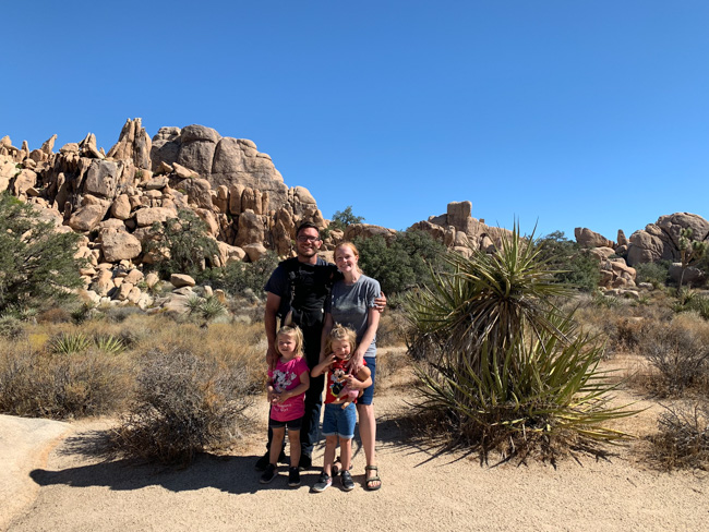 A family of visitors exploring Joshua Tree in December.
