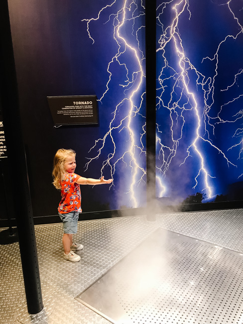 A child exploring an exhibit at The Clark Planetarium. Playing here is one of the best things to do in Salt Lake City in winter.