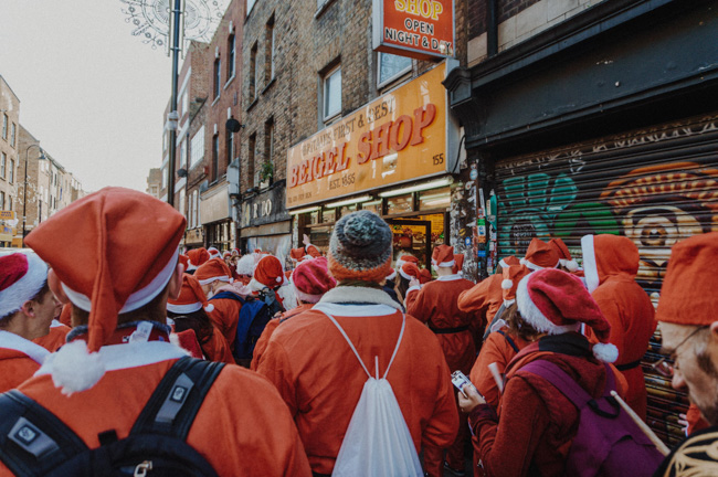 A crowd all dressed in Santa costumes.