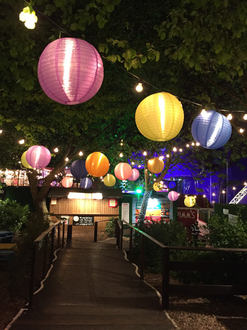 Zoo in Seattle in December, adorned with colorful lanterns and string lights hanging from the trees.