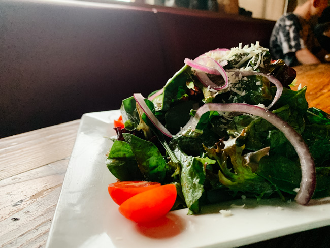 Salad on a plate in a restaurant in Los Angeles, one of the best places to visit in California in winter.