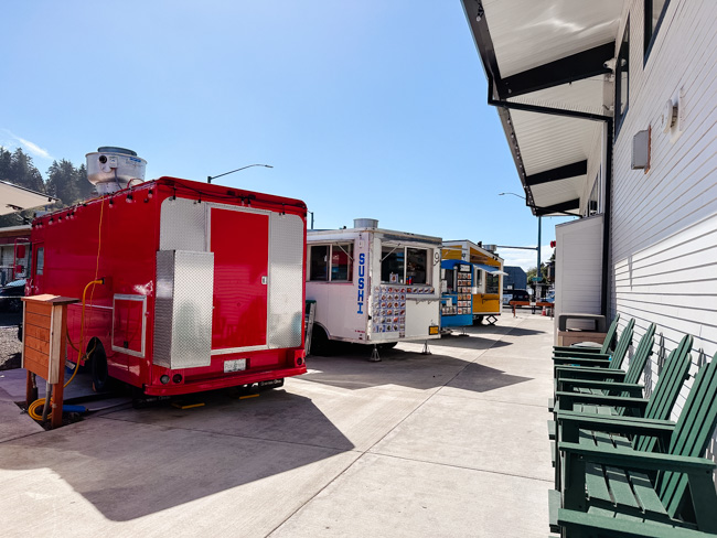 Several food trucks parked at the food truck village. These spots are some of the best Lincoln City restaurants.