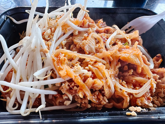 A to-go container full of an Asian-inspired vegetarian dish.
