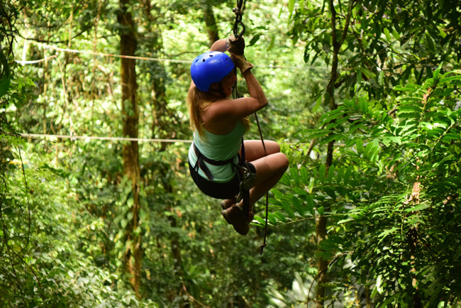 A woman ziplining in Oahu in January.