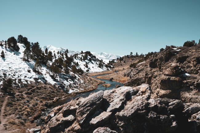 Rocks, river and snowy hillside around Mammoth Lakes.