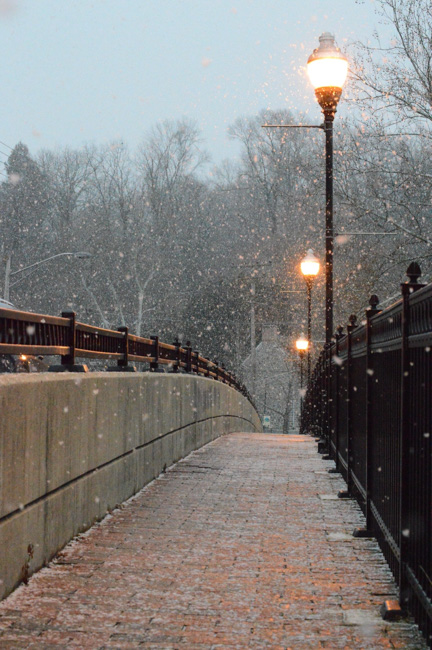 Light snow falls on a walkway in Santa Monica.