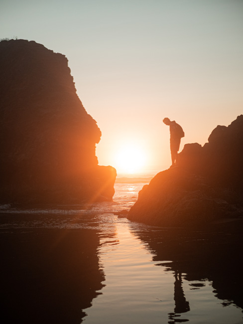 A man exploring Nehalem Bay State Park, one of the best things to do in Cannon Beach.